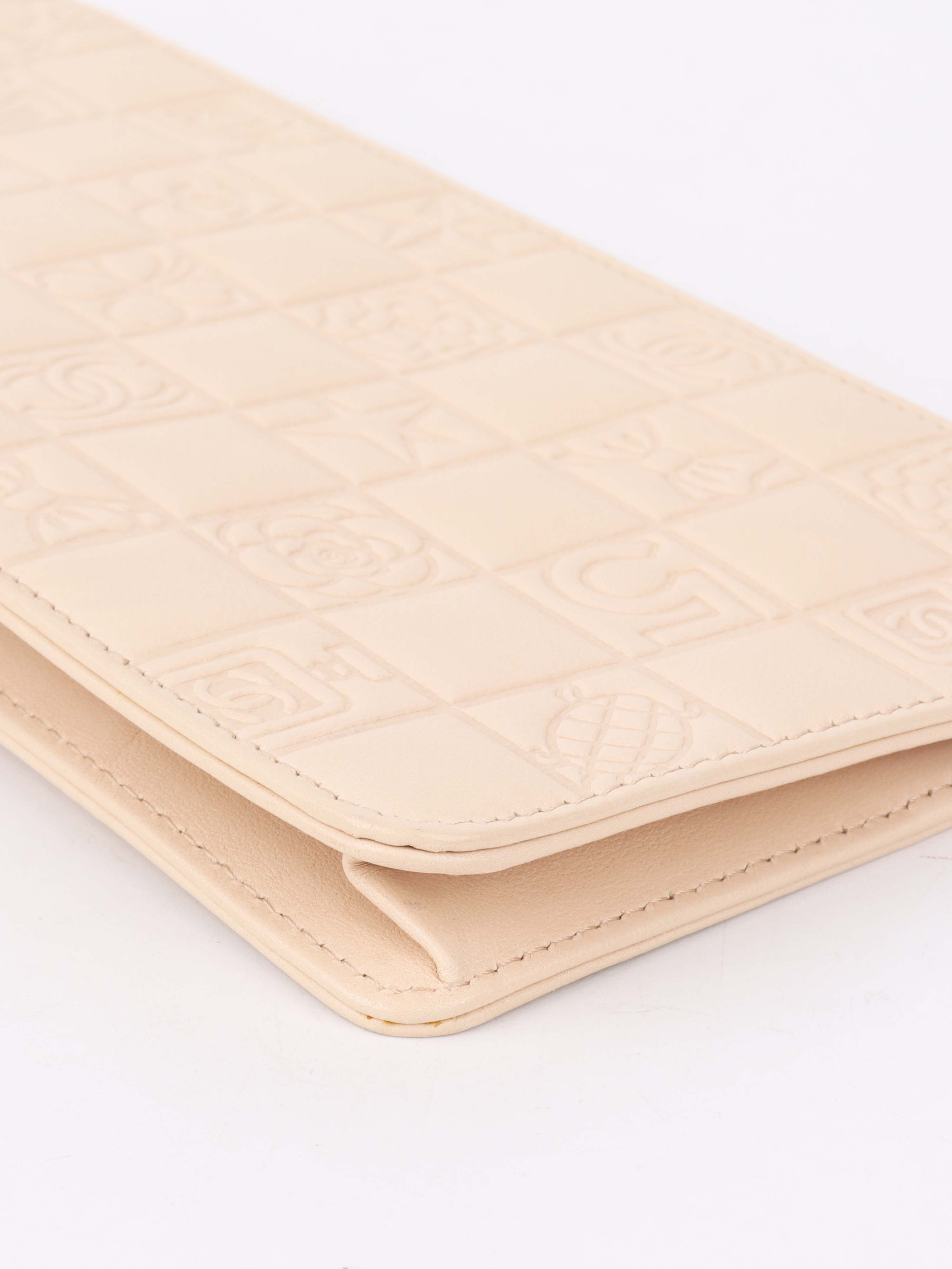 Chanel Beige Lucky Embossed Symbols Pochette with Wristlet Chain.