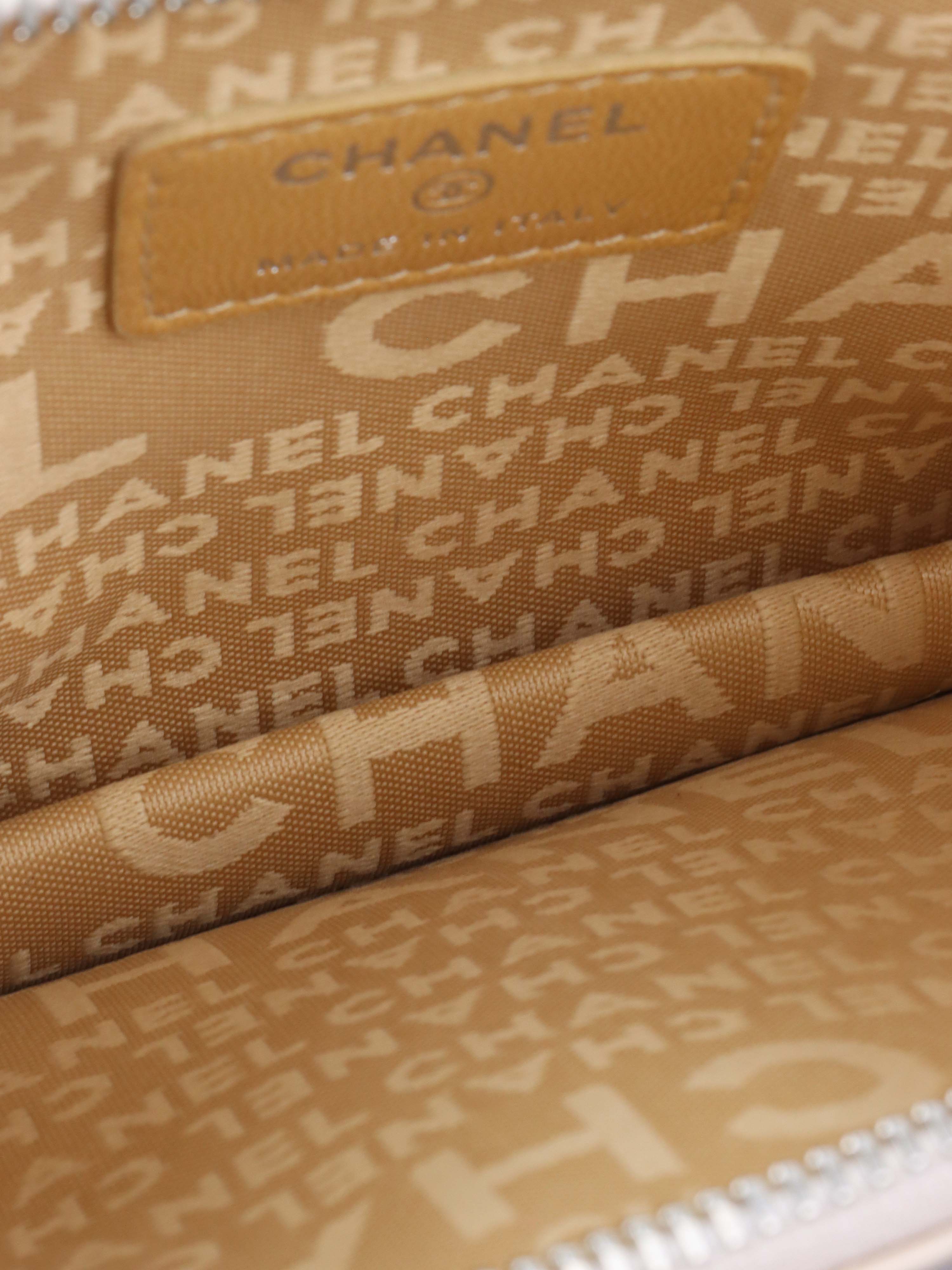 Chanel Beige Lucky Embossed Symbols Pochette with Wristlet Chain.