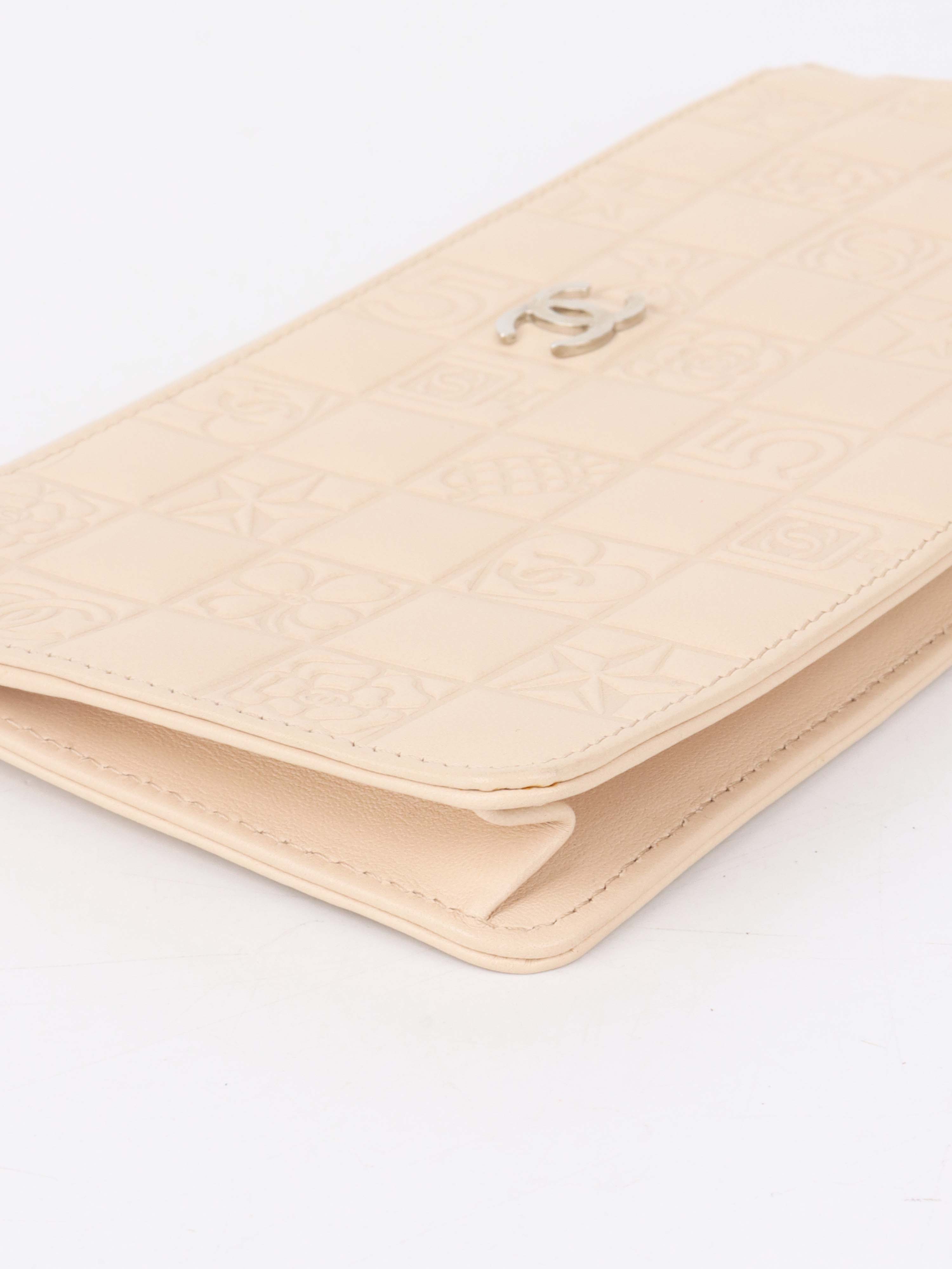 Chanel Beige Lucky Embossed Symbols Pochette with Wristlet Chain.